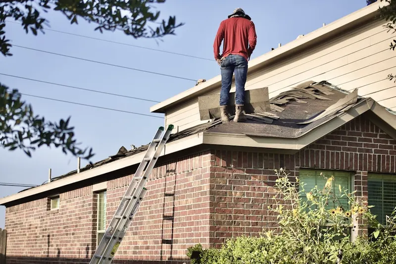 Professional roofer working on a residential roof in Mineola